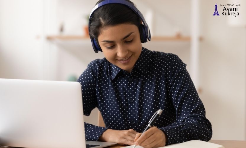 Young learner studying with laptop and headphones during online French classes in India